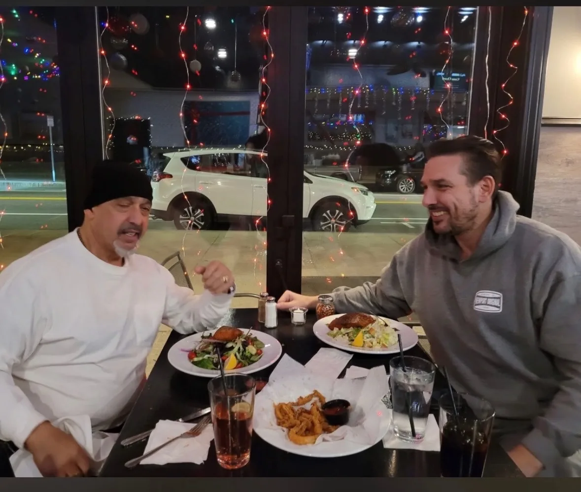 Rob G sharing a meal and conversation with a friend in recovery