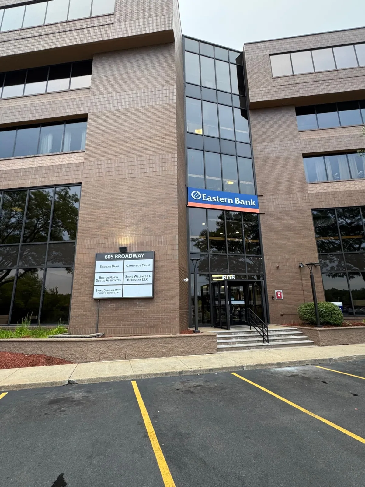 Main entrance of 605 Broadway in Saugus, MA, the brick office building where Shine Wellness & Recovery is located