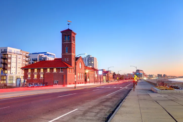 Revere Beach boulevard at dusk with historic brick building along the waterfront
